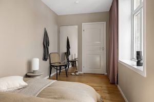 modern window shade installation in bedroom